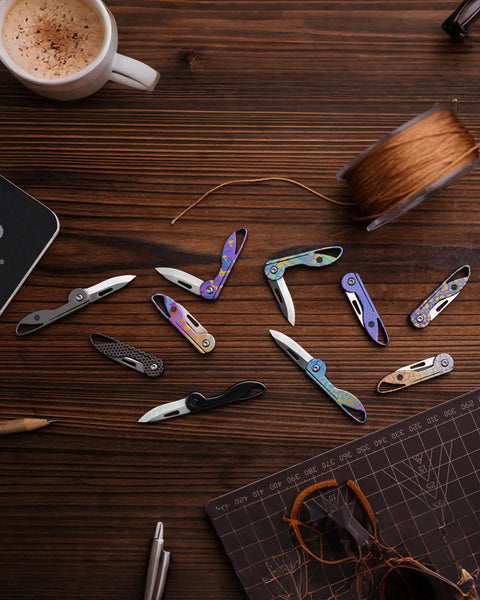 Mini Titanium Pocket Knife For Everyday Carry With Razor Sharp Folding Blade displayed on wooden table with EDC tools