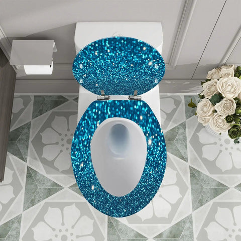 Elongated Toilet Seat Blue Glitter Resin for Bathroom on a white toilet with decorative floor tiles and flowers.