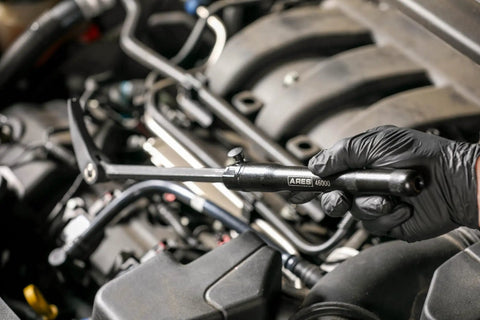 Mechanic using Extendable Pry Bar With 13.3 To 18.5 Inch Reach 14 Position Adjustable Angled Head in engine bay