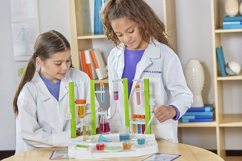 Two girls using Ooze Labs Chemistry Station Science Kit For Kids With 57 Pieces And 20 Safe Experiments Including Slime Making