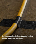 Extra Heavy Duty Industrial Duct Tape 6969, Gray, secures wet yellow cable on floor, abrasion resistant.