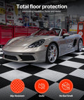 Interlocking Garage Floor Tiles 16 Pack, Diamond Plate Texture Non Slip PVC Floor Mats, 20.2x20.2x0.2 Inches, Graphite Gray, Quiet, Durable, DIY Friendly, Easy Install for Garages, Workshops, and Warehouses. Installed under a sports car in a garage.
