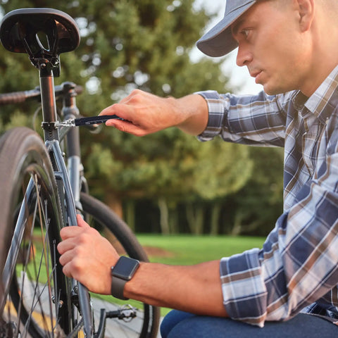 Man using Nine In One Multitool Pen Set Great Stocking Stuffers For Men Dad Boyfriend Husband From Daughter Cool Gadgets For Guys Who Have Everything Perfect Gift For Christmas And Everyday Use With Durable Aluminum Build And Sleek Design to fix bicycle outdoor