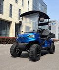 Heavy Duty Electric Golf Cart With Four Kilowatt Motor And Easy Directional Controls, blue two-seater with cargo space, urban setting.