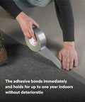 Applying Heavy Duty Duct Tape, Silver, 1 Pack, 1.88 in x 60 yd x 9.0 mil for sealing carpet edges on floor surface