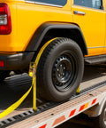 E Track Tie Down Kit With Four Rails And Twenty One Accessories For Garages And Trailers securing yellow vehicle's rear wheel