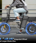 Person riding 1200W Folding Electric Bike For Adults And Teens, 25 MPH Peak Power, full suspension, black, on urban street