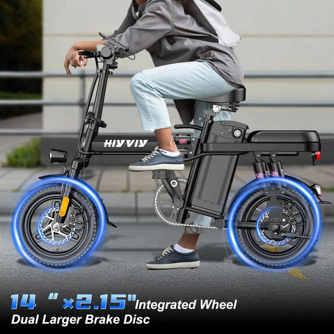 Person riding 1200W Folding Electric Bike For Adults And Teens, 25 MPH Peak Power, full suspension, black, on urban street