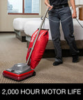 Hardcore Commercial Upright Bagged Vacuum Cleaner With Vibra Groomer Brush Roll, Fifty Foot Power Cord, Six Decked Out Height Settings, Beefy Long Life Motor, And Zero Hassle Shake Out Bags in use on low pile carpet.