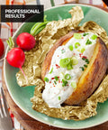 Baked potato topped with sour cream and chives placed on a heavy duty aluminum foil sheet.