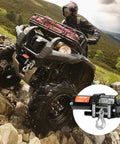 VEVOR 4000 Lb Electric Winch For Atv And Utv Recovery mounted on an ATV tackling rocky terrain with a rugged backdrop.