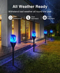 Solar Outdoor Lights 6 Pack Tiki Torches With Flickering Flame illuminating a garden pathway during rain, showcasing waterproof feature.