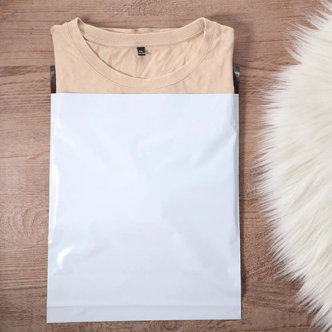 240 Pack Poly Mailers With 6 Sizes Self Adhesive Waterproof Tear Resistant Shipping Envelopes For Clothes Books Gifts White Assorted Sizes Durable Packing Bags containing a folded beige shirt on wooden surface