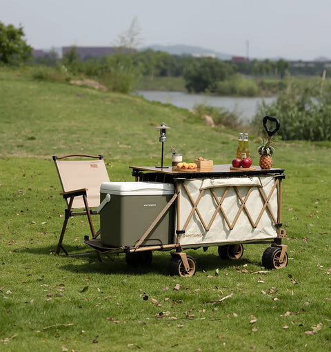 Collapsible Folding Wagon With Built In Table And All Terrain Heavy Duty Utility Cart For Camping Beach Garden And Sports Open Tailgate Design Beige Portable on grass with cooler and food items