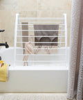Freestanding Indoor Clothes Drying Rack Foldable Garment Hanger Compact Space Saving Design Lightweight White Finish with drying clothes.