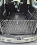Dodge Durango Trunk Mesh Cargo Net Envelope Style For SUVs 1998 2026 in use, securing items in rear storage area of SUV
