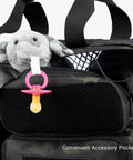 Pacifier and stuffed toy in accessory pocket of Deuce 4th Gen Tactical Diaper Bag For Dads With Included Changing Mat And Stroller Straps Water Resistant 600D Polyester