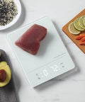 Digital Waterproof Kitchen And Food Scale IPX7 With LED Display 11 Lb Max Capacity Built For Home Cooks Dry Or Wet Ingredients Rinse Under Faucet For Easy Clean White with fish and vegetables.