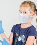 Girl wearing Kids KF94 Face Mask For Protection White 20 Pack Made In Korea Premium KF94 Certified Dust Mask For Small Faces