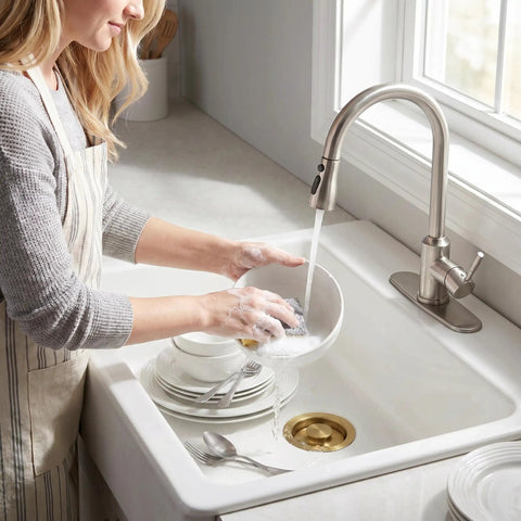 Woman washing dishes in sink with Golden Stainless Steel Garbage Disposal Flange And Sink Stopper For Three And One Half Inch Drain Hole Dope Frosted Gold Finish That Resists Discoloration Easy Install Kitchen Sink Accessory visible.