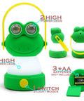 Green lantern with frog face design, yellow handle, showing LED lights and battery compartment of Owl Themed Kid Friendly LED Lantern And Headlamp Set.
