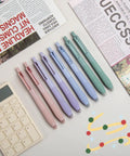 Gel Pen Set With 0.5mm Fine Point Black Ink For Smooth Retractable Writing Perfect For Office And School 12 Count With Comfortable Non Slip Grip A Go To Everyday Carry Essential For Clear Bold Lines displayed with colorful pens and accessories