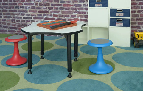 Glow 15 Inch Blue Stool For Classrooms And Playrooms With Convex Base next to table in playroom