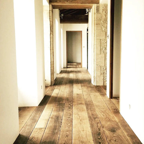 Wood floor stained with Top Shelf Golden Oak Reactive Wood Stain, featuring classic amber glow in a hallway setting.