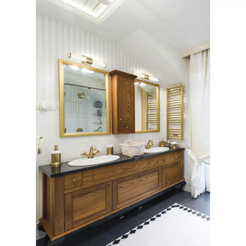 Bathroom with wooden vanity and mirrors under Caper 24 Inch LED Vanity Light In Brushed Brass With Frosted Lens Dimmable Hardwired Fixture