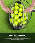 Hands using Tennis Ball Pickleball Roller Collector No Bending Over Quick Roll Up For 1.5 To 3 Inch Balls, on grassy surface.