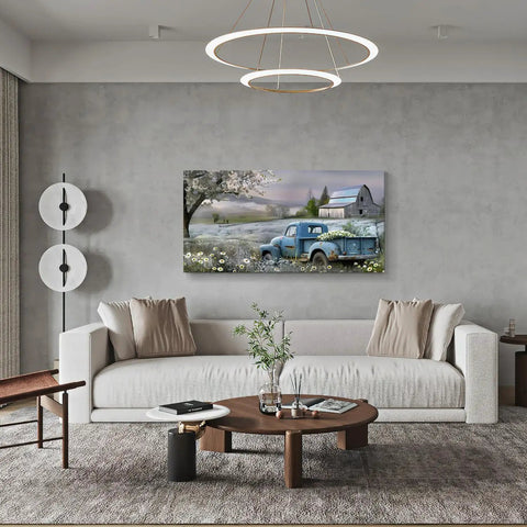 Farmhouse canvas wall art blue vintage pickup truck with blooms over rustic barn scene in living room 58x28 inches