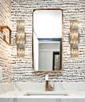 Bathroom with twin Chrome Crystal Wall Sconce With Four Lights Modern Tube Shape Glass Wall Light Fixture beside a mirror.