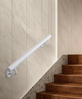Built Like A Tank Two Foot White Steel Stair Railing With Heavy Duty Wall Mount Brackets To Keep Your Footing Locked Down On Indoor And Outdoor Steps As A Senior Grab Bar installed on wall next to wooden steps.