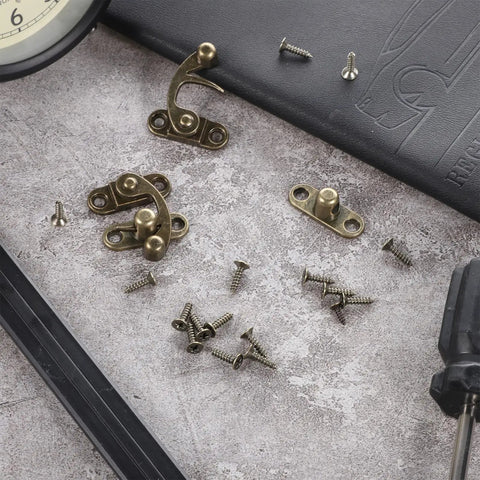 Two Piece Bronze Zinc Alloy Swing Arm Hasp Latch Set With Heavy Duty Mounting Screws For Jewelry Boxes Cabinets And Toolboxes on a work surface.