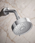 Purist Three Function Showerhead 2.5 Gpm Polished Chrome mounted on marble wall, side view highlighting spray nozzles