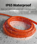 100 Ft 12/3 Outdoor Extension Cord Waterproof Heavy Duty with Lighted End coiled, wet in rain, showcasing weatherproof feature