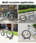 Heavy Duty Indoor Bike Floor Stand Adjustable Single Wheel Rack for Garage Ready Setup Fits 16 to 29 Inch Wheels and Up to Three Point Five Five Inch Tire Width Ideal for Mountain Road BMX and City Bikes in various settings