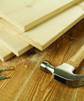 Bright Steel Framing Nails 14 Gauge Half Inch Wood Fasteners Built For The Daily Grind with wooden planks and a hammer.
