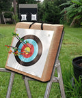 Backyard Archery Target Set for Compound and Recurve Bows, straw backstop with arrows on target in grassy yard