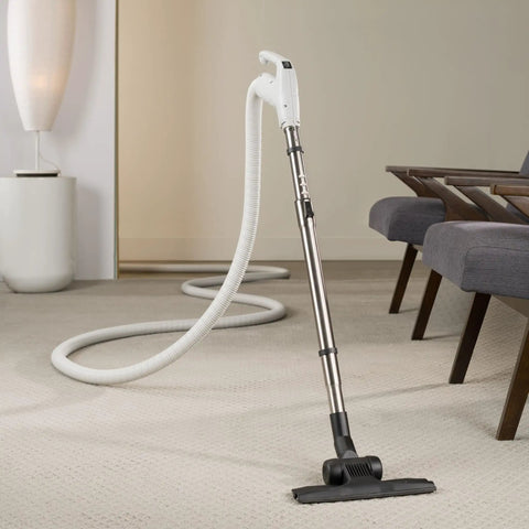 Universal 30 Ft Central Vacuum Kit With Suction Driven Turbo Nozzles shown cleaning carpet near a modern sofa