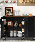 54 Inch Farmhouse Kitchen Cart Featuring A Nifty Power Outlet And Hefty Storage Space With Smooth Rolling Lockable Wheels And Sleek Black Finish, showcasing storage compartments.