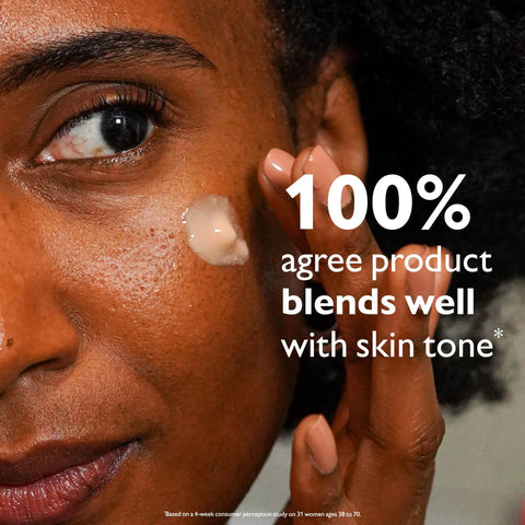 Woman applying Instant Skin Tightening Primer For Face That Blurs Imperfections Firms On Contact Reduces Fine Lines And Pores