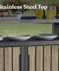 Wood Look Outdoor Entertainment Cart With 78 Gallon Storage, Stainless Steel Top For BBQ Prep, Weather Resistant Resin, Patio Deck Backyard Party Station, DecoCoat Finish In Ashwood showing plates and drinks.