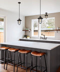 Modern kitchen with Oakmont Two Handle Kitchen Faucet With Side Sprayer In Oil Rubbed Bronze on central island.