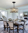 Three Light Modern Crystal Chandelier In Black Metal Farmhouse Pendant Light With E26 Base over a dining room table.