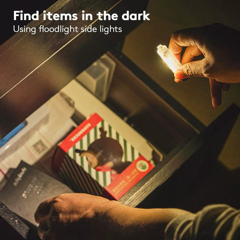 Hand holding Aurora A7 G4 7075 USB C Rechargeable Keychain Flashlight 650 High Lumens illuminating drawer for finding items