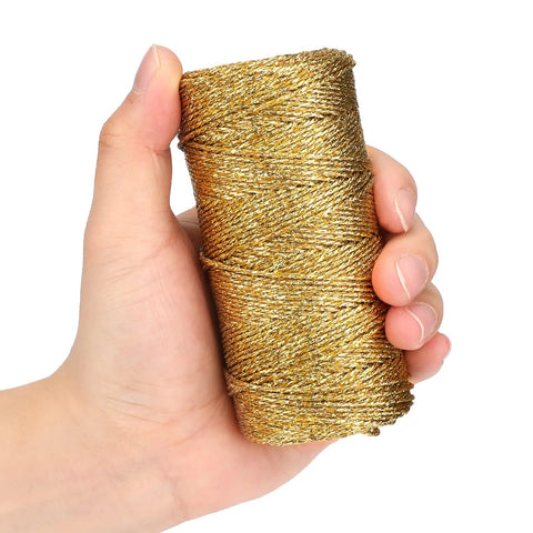 Hand holding Decorative Metallic Bakers String Gold Twine 110 Yards 1.5mm Inelastic Glitter String for DIY Crafting
