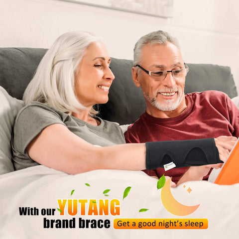 Couple relaxing on couch with black Carpal Tunnel Wrist Brace Go-To Night Sleep And Daywear All Day Comfort Cushioned Bead Wrist Support
