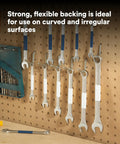 Tools with white vinyl tape labels hang on a pegboard demonstrating Vinyl Tape 764 General Purpose White 3 Inch By 36 Yard Roll use.