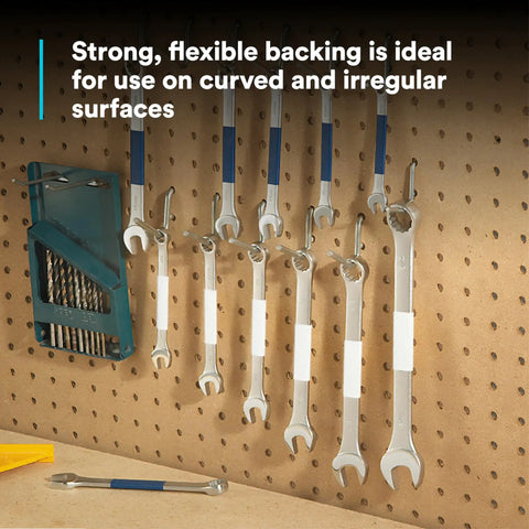 Tools with white vinyl tape labels hang on a pegboard demonstrating Vinyl Tape 764 General Purpose White 3 Inch By 36 Yard Roll use.